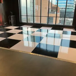 Glossy black and white dance floor rental in Fort Lauderdale for elegant wedding receptions.