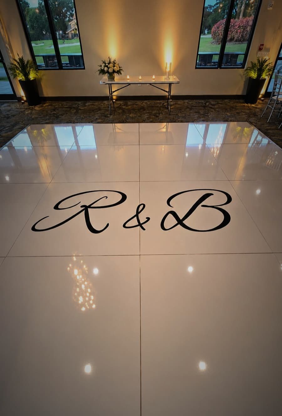 Luxury white dance floor with custom wedding logo installed for an upscale celebration.