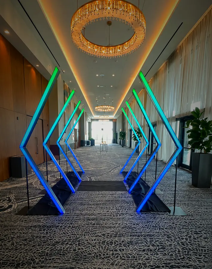 Angled square LED tunnel rental with red lighting at an event venue in Miami