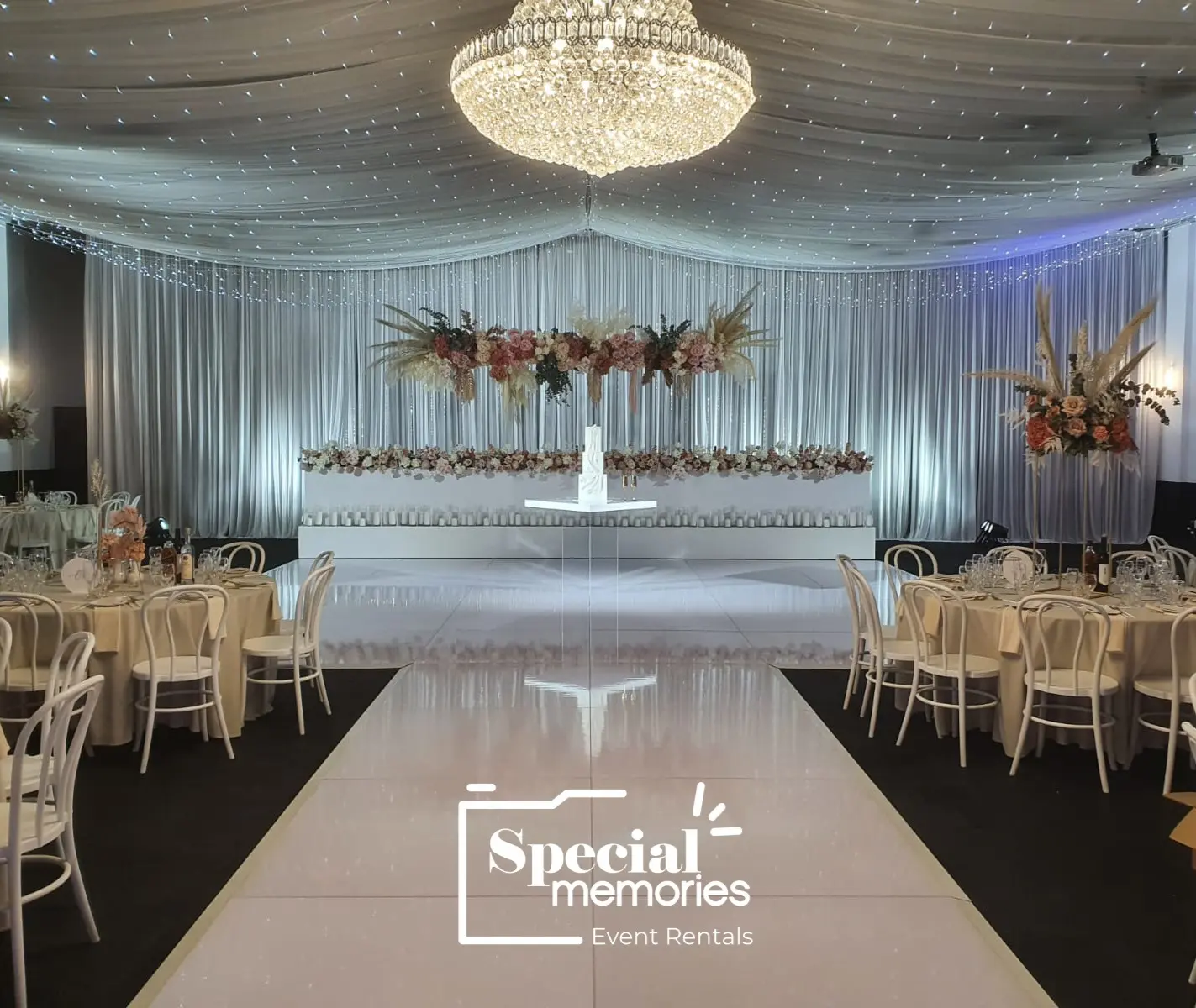 Elegant white dance floor reflecting wedding décor and lighting at a luxury ballroom.