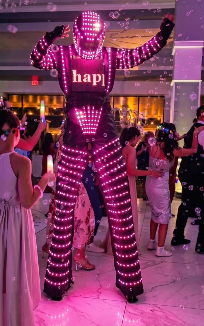 LED robot and professional female dancer hyping the crowd during Hora Loca