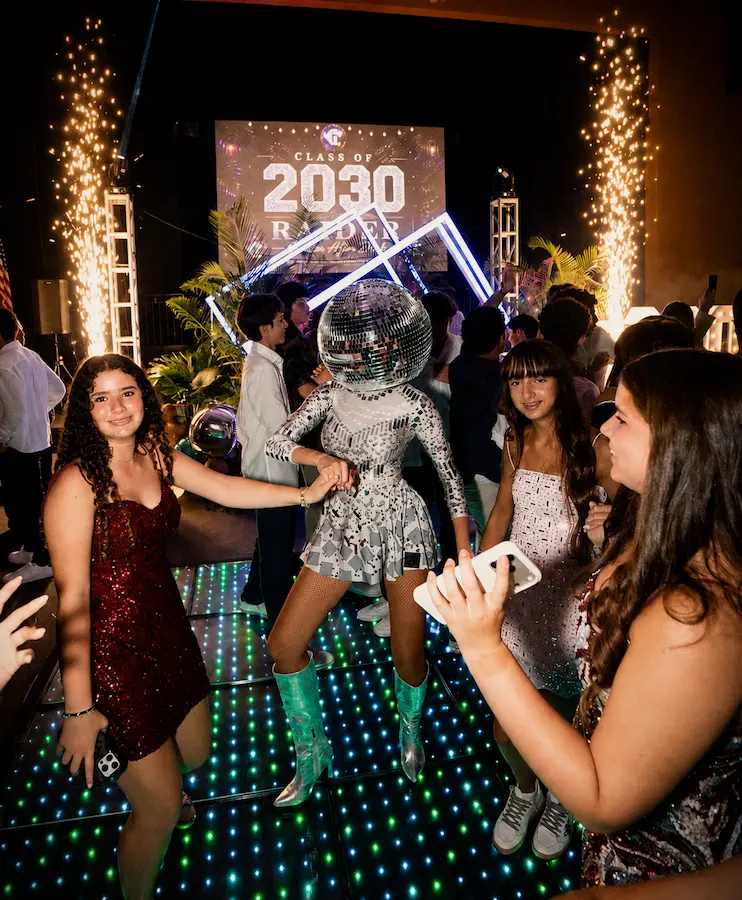 Cold spark fountains and low-lying fog around a light-up LED dance floor at a Coral Gables school event