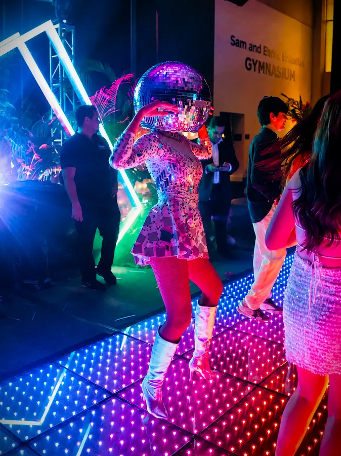 Professional dancer on a glowing 20 by 20 Pixel LED light-up dance floor at a Coral Gables school event