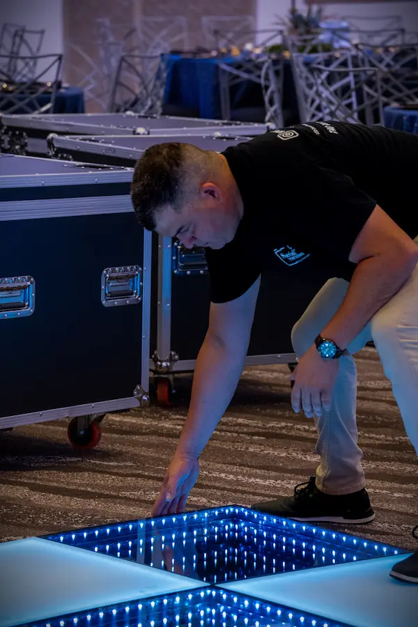 Special Memories FL team member checking an Infinity LED floor panel in Sunrise Florida