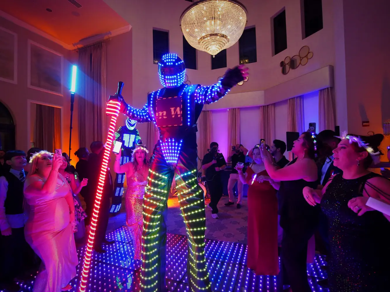 LED robot performing with wedding guests on a Pixel LED dance floor at a Parkland wedding reception