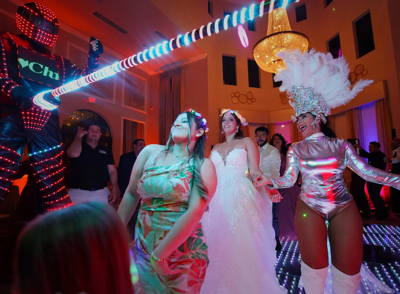Bride with an LED robot and professional female dancer during Hora Loca at a Parkland wedding