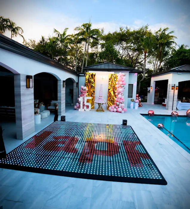 Daytime poolside setup with a Pixel LED dance floor and two cold spark machines for a quinceañera in Kendall Miami