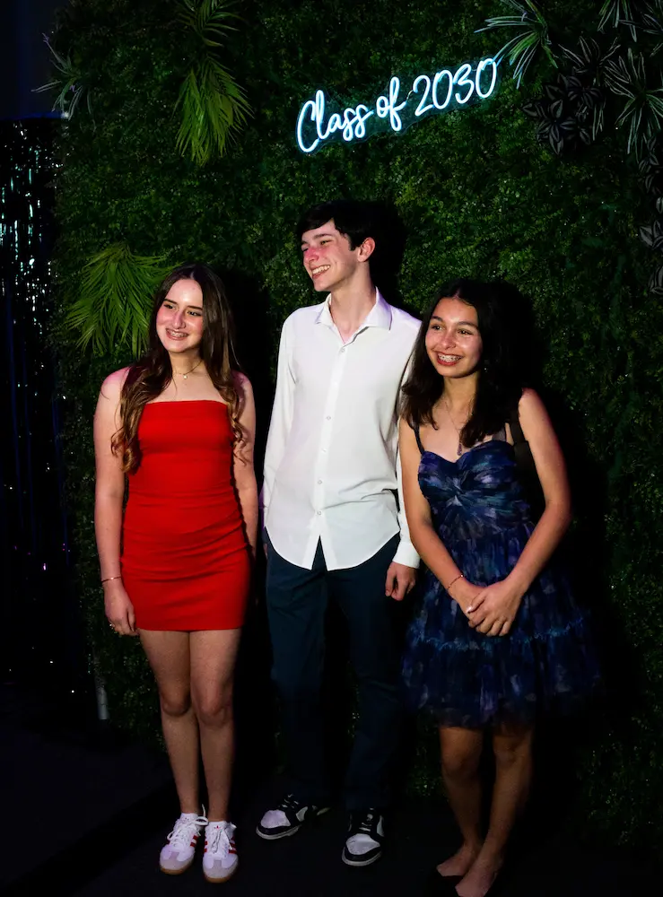 Artificial greenery wall and faux foliage photo backdrop at a Coral Gables school dance