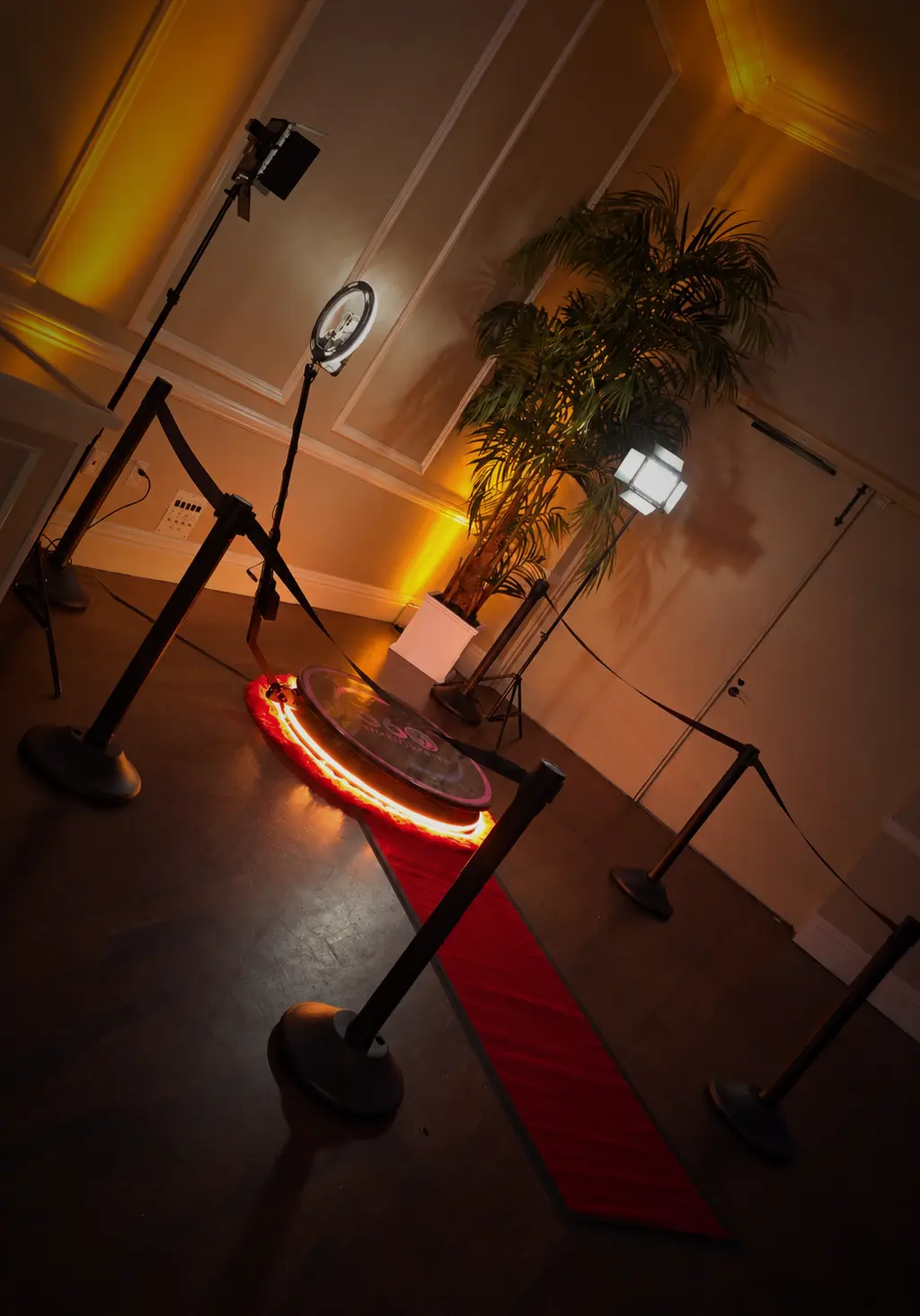 Classic 360 video booth with red carpet and lighting at a Jupiter wedding reception