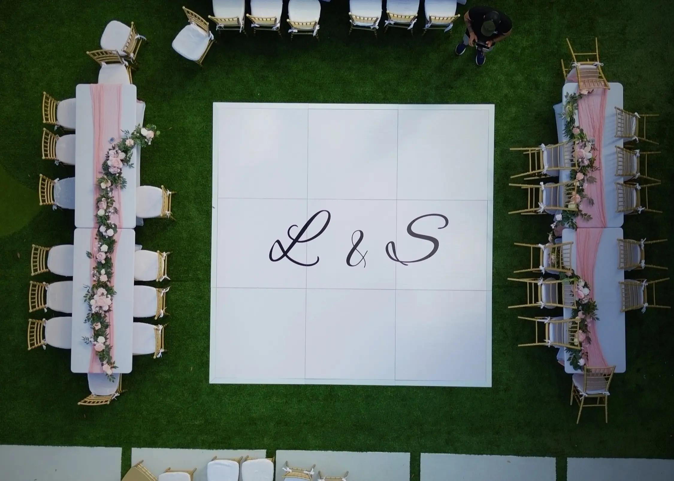 Overhead view of a white dance floor with L and S initials at a Miami backyard wedding