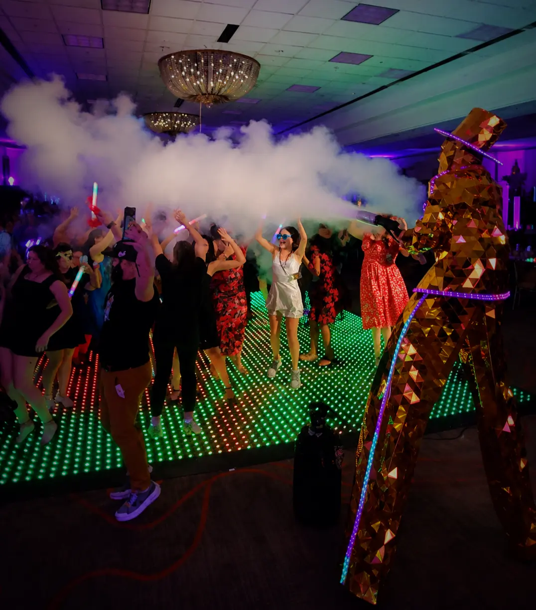 Bat Mitzvah guests celebrating on a Pixel LED dance floor with a gold Mirror Man performer in Coral Springs