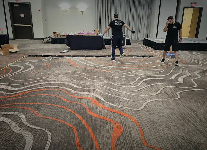 Special Memories FL team marking the layout and preparing power for a 20 by 20 LED dance floor installation at a Coral Springs Bat Mitzvah