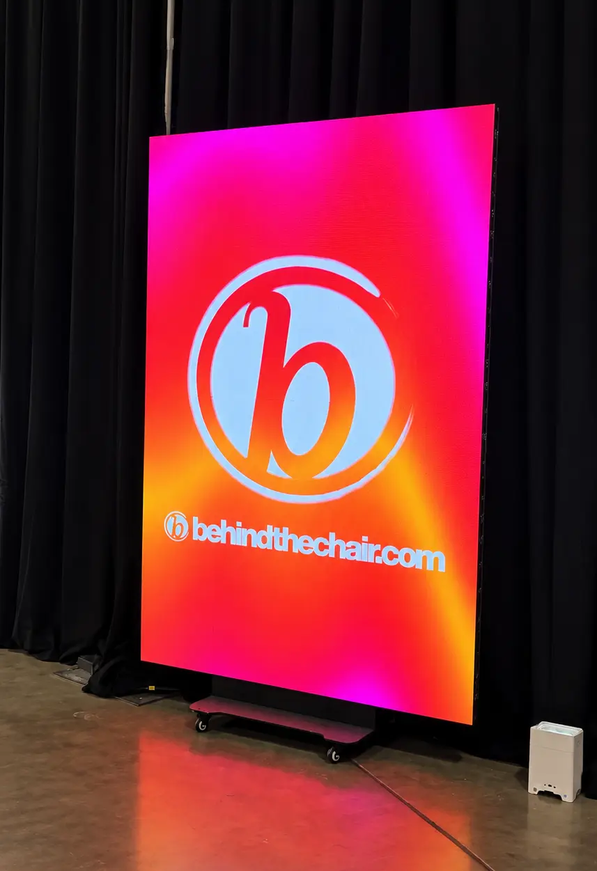 Vertical LED screen displaying corporate branding at a Palm Beach event