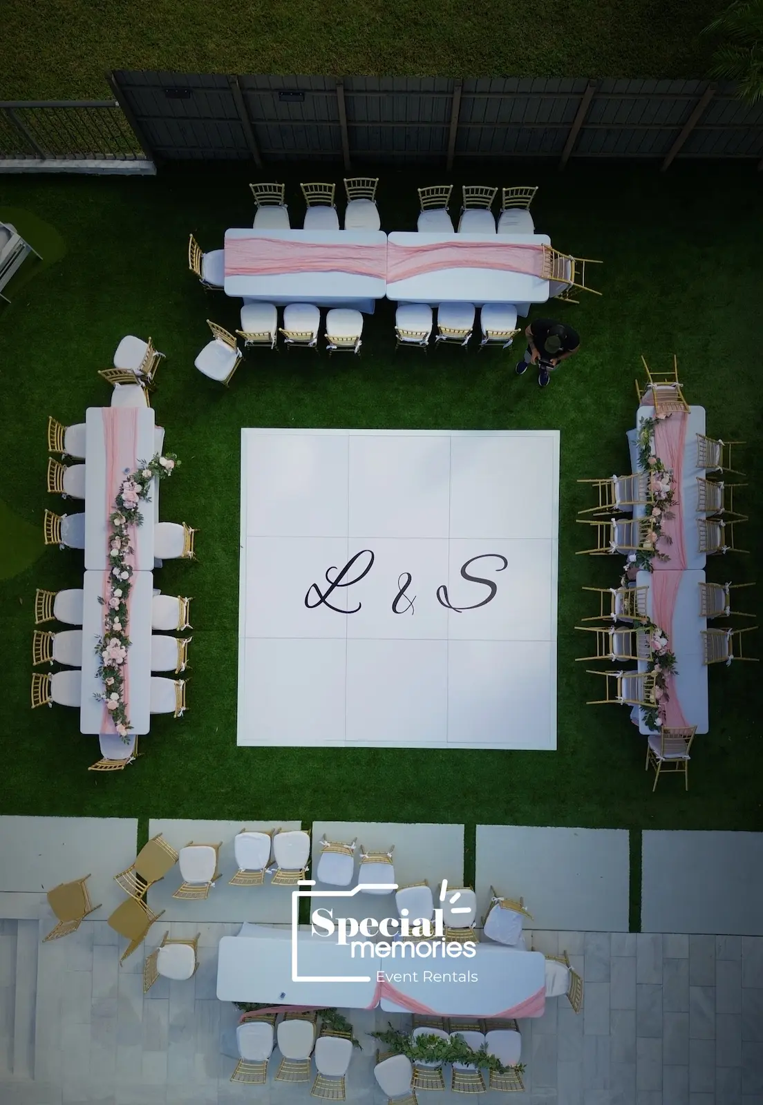 Aerial view of custom L and S vinyl initials on a white wedding dance floor in Miami
