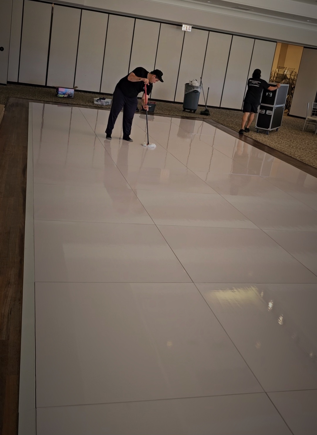 Special Memories FL team preparing and cleaning a glossy white wedding dance floor in Palm Beach County