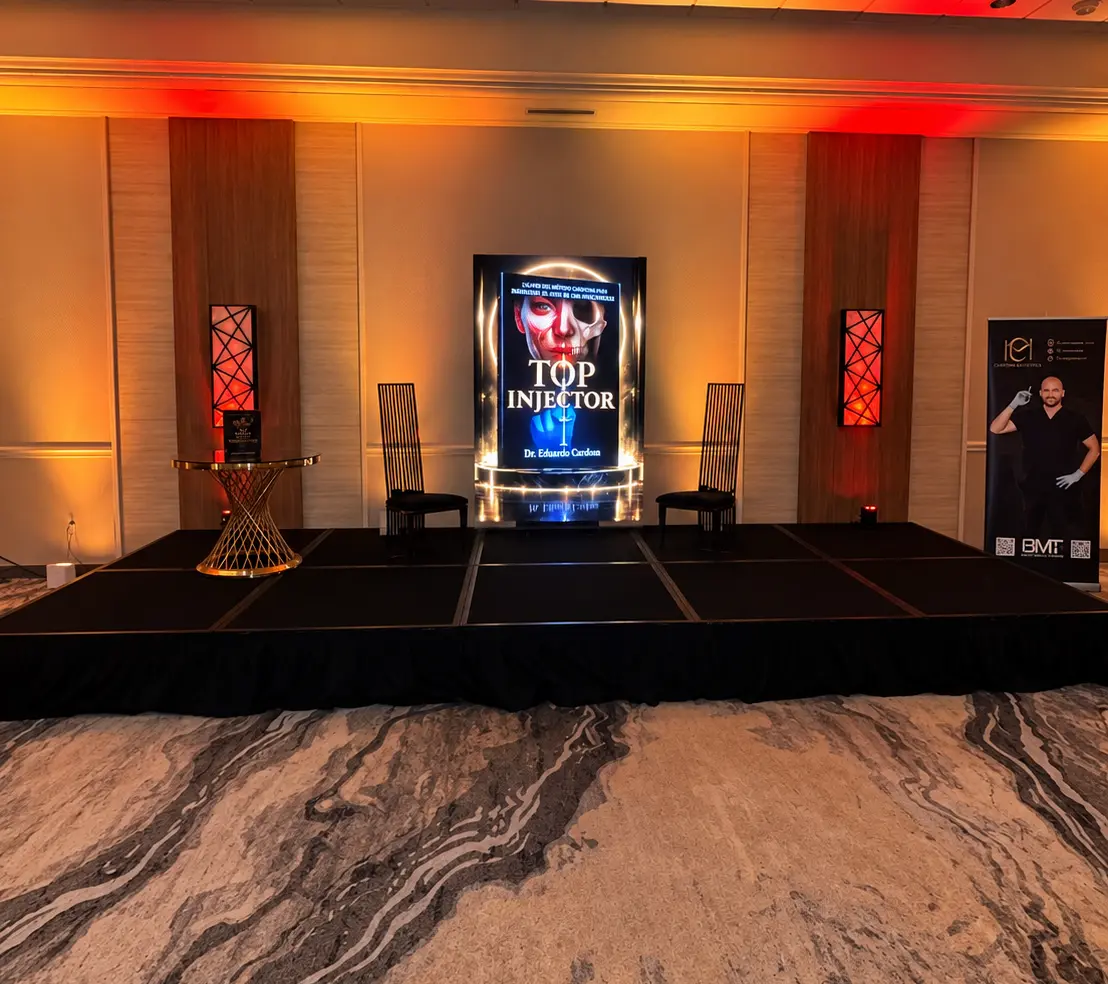 Top Injector book launch stage in Miami with a high-resolution vertical LED screen displaying branded book artwork