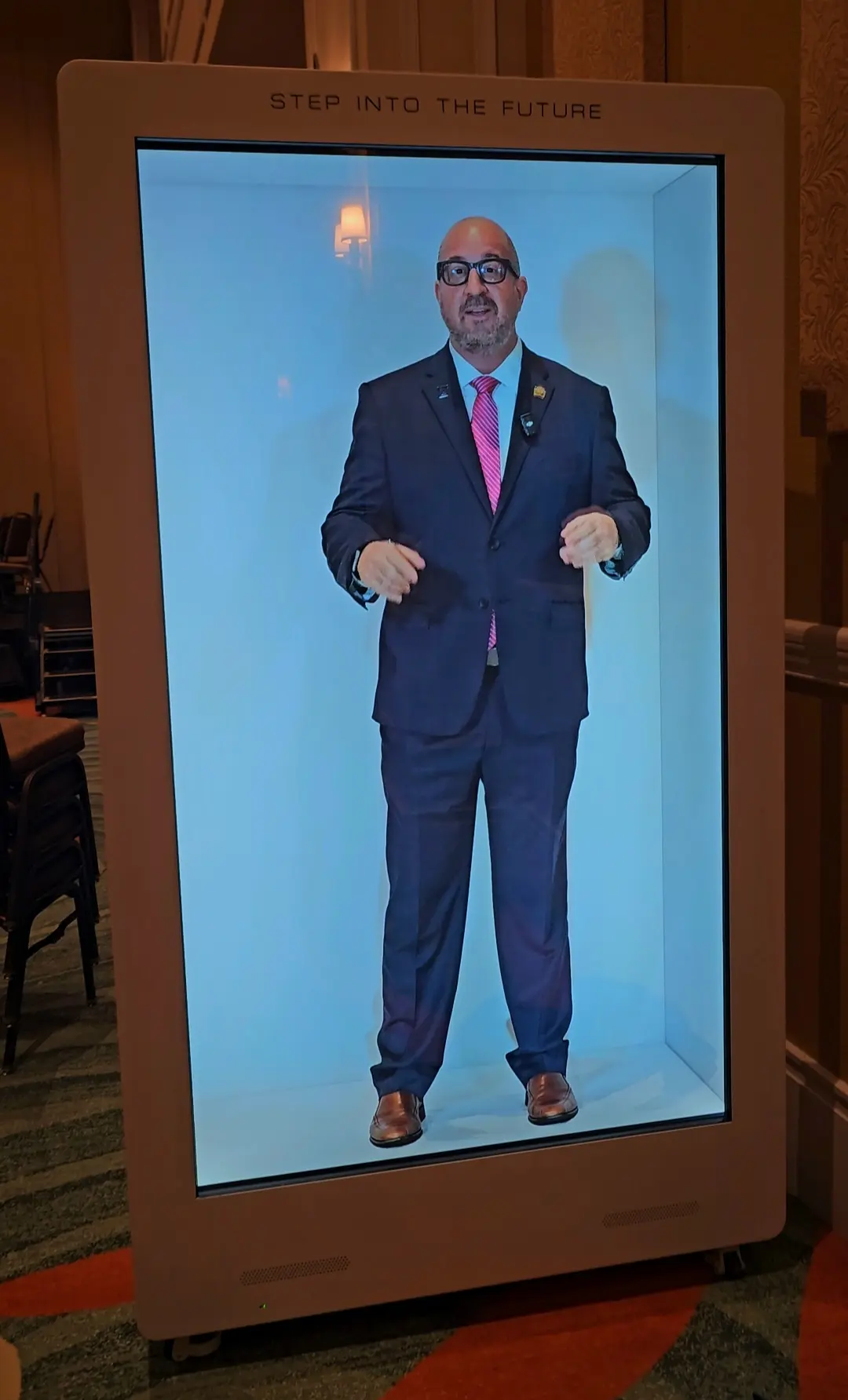 Holographic welcome display showing a prerecorded corporate speaker at an Orlando event