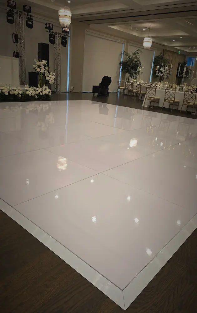 Clean 24 by 24 glossy white wedding dance floor installed before a Jupiter reception