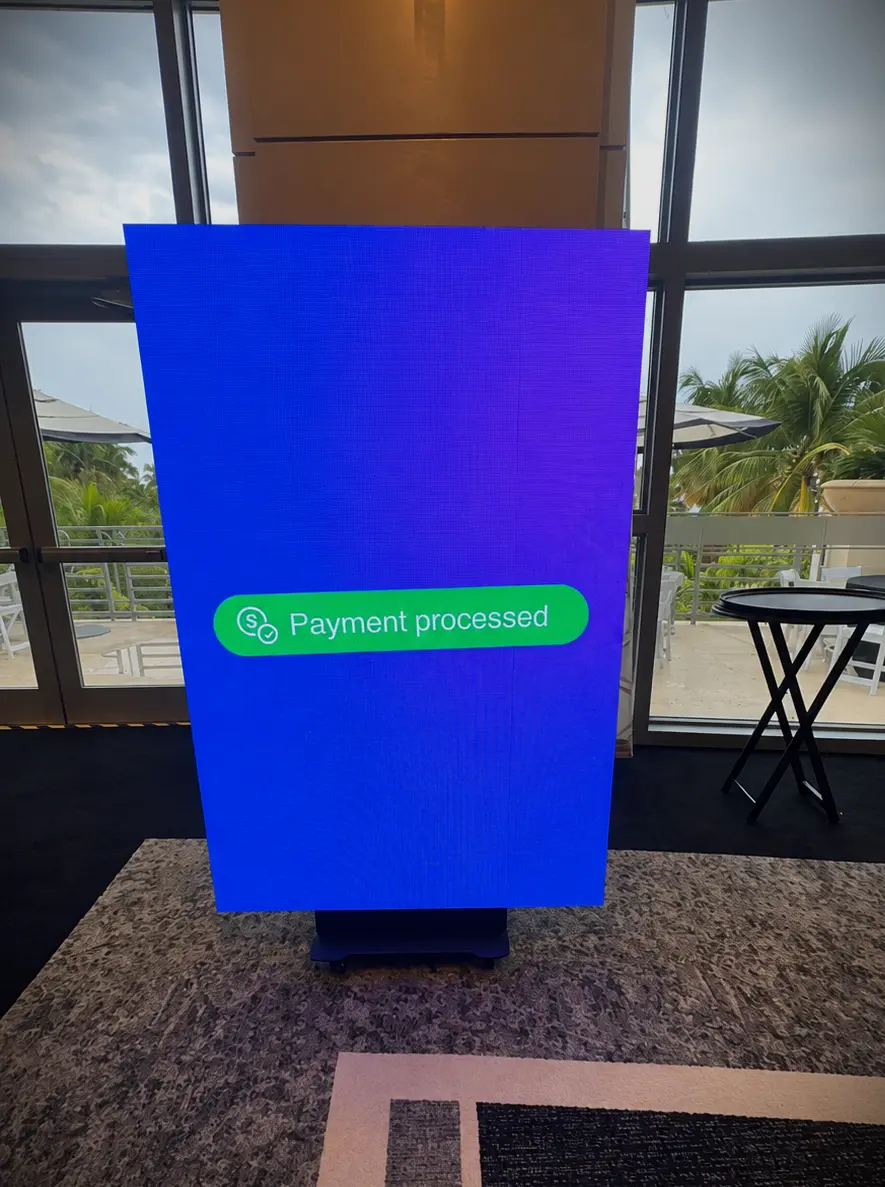 Multi-day vertical LED screen displaying Xplor Momence payment processing content in Miami Beach