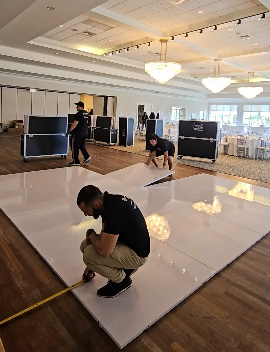 Large white wedding dance floor being installed at Indian Spring Country Club in Boynton Beach