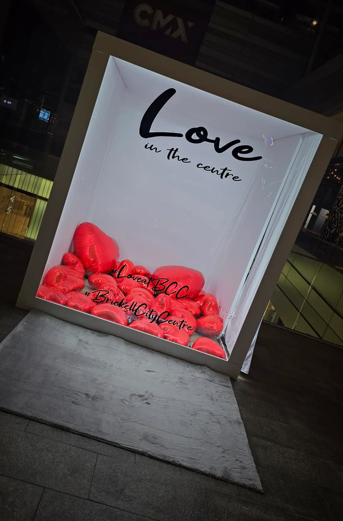 Valentine’s Day Magazine Cover Booth in Brickell Miami with illuminated white interior and red heart balloons