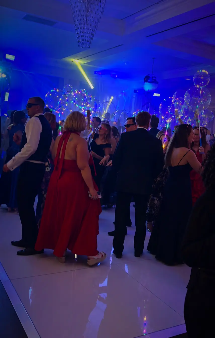Wedding guests celebrating on a white dance floor during a Palm Beach County reception