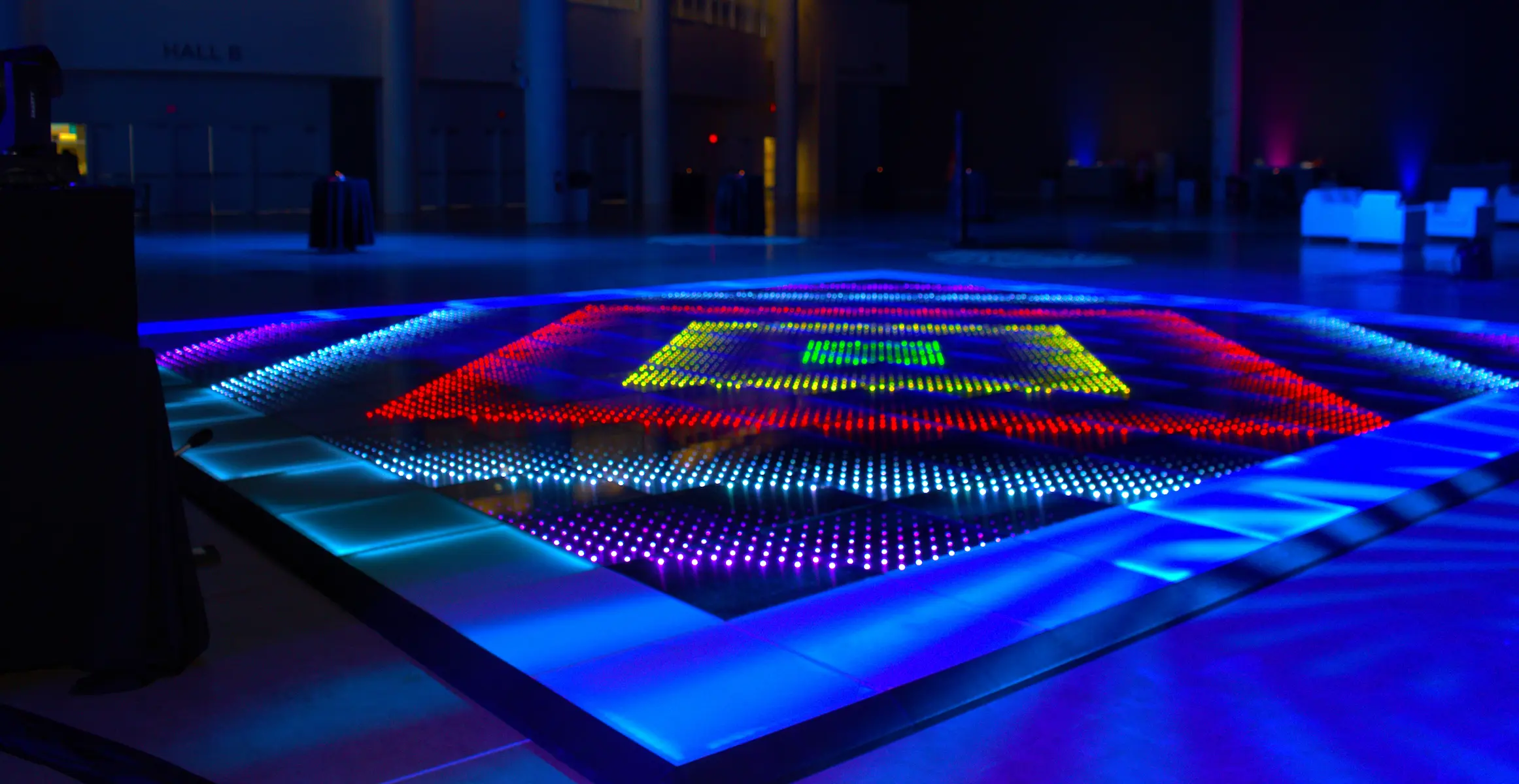 Pixel LED dance floor with colorful square patterns at Behind the Chair in Fort Lauderdale