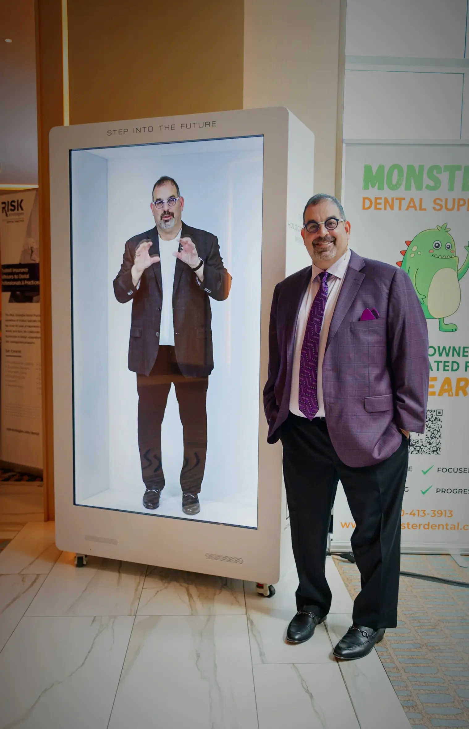 Dr. Len Tau beside his hologram at the Supercharge conference in Fort Lauderdale