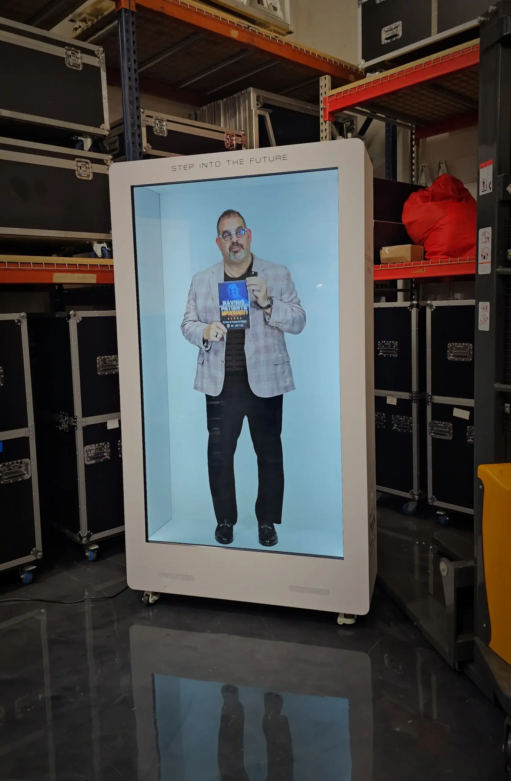 Company representative appearing inside a hologram box at a corporate event.